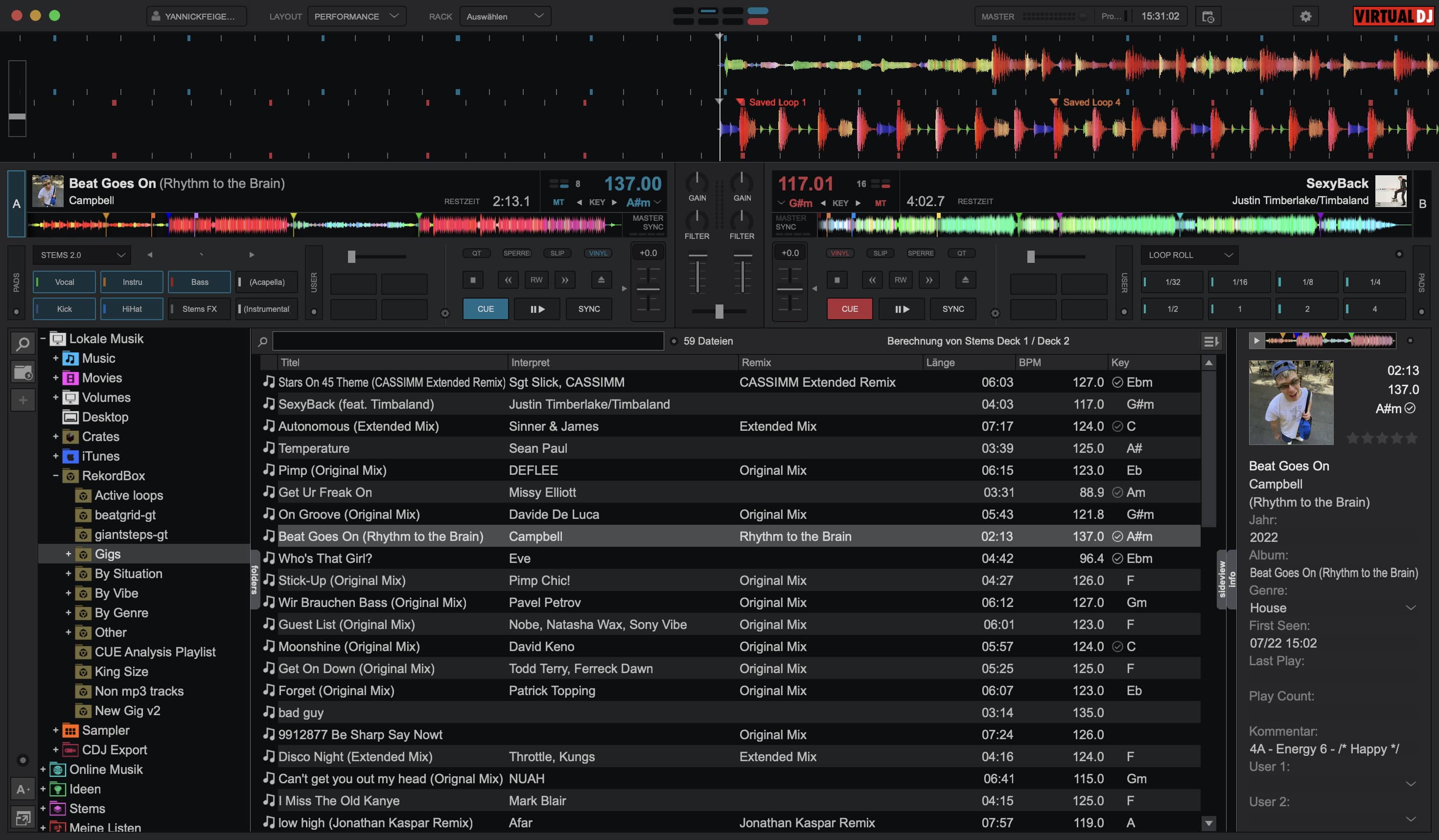 VirtualDJ performance layout with decks, colored waveforms, stems, pads, browser, and track information